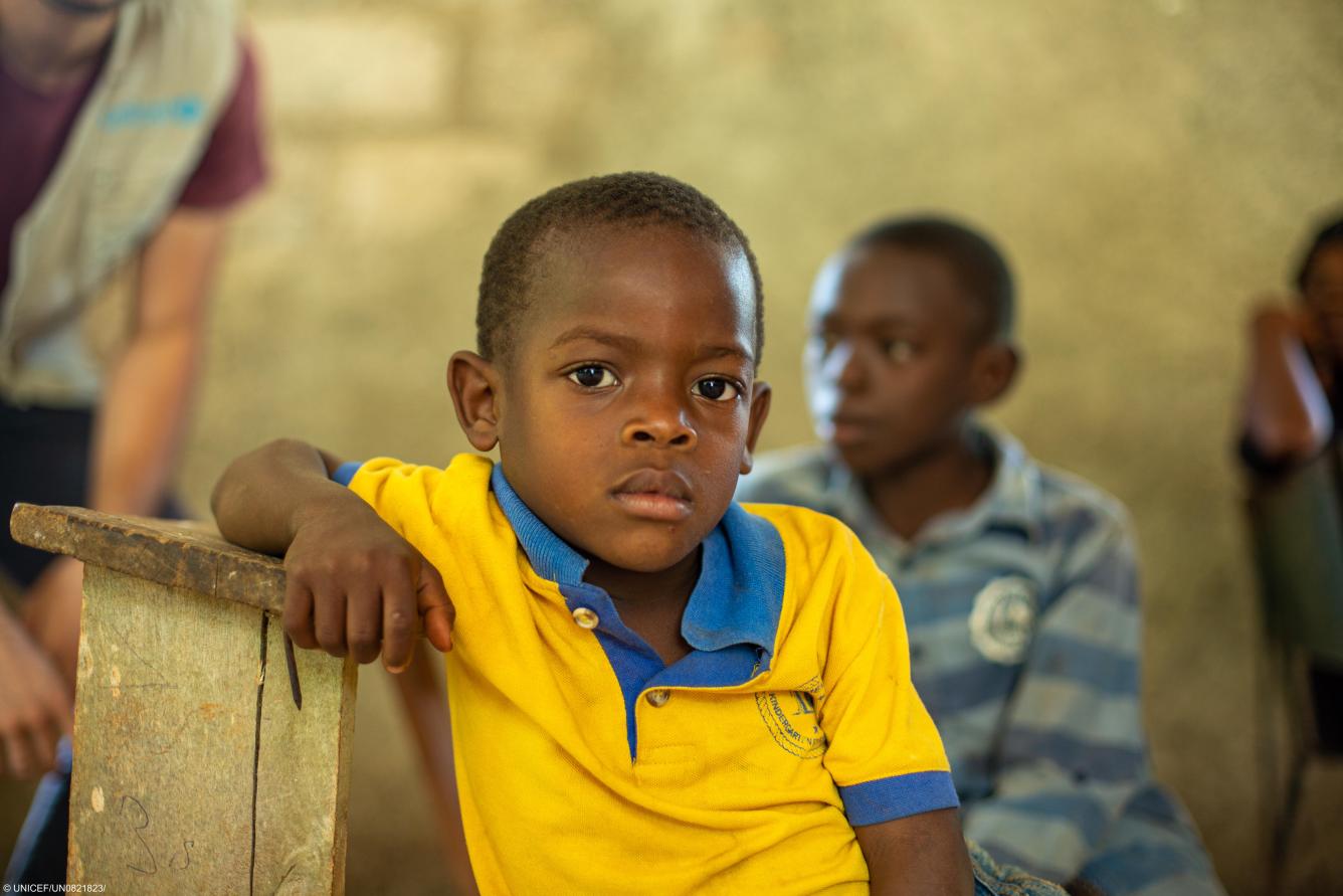 A boy sits during an interview with beneficiaries of a clean water programme run by UNICEF in Jeremie, Haiti.
