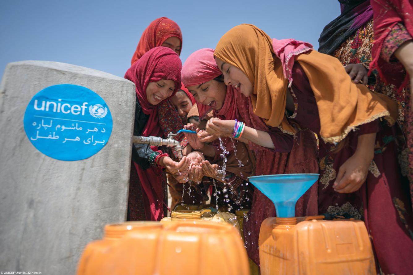 A group of girls drink water from a tap installed with UNICEF support in Balkh Province, Afghanistan.