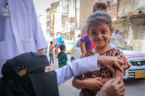 A young girl receives a Measles and Rubella vaccine during a UNICEF-backed mobile vaccination campaign in Aden, Yemen.