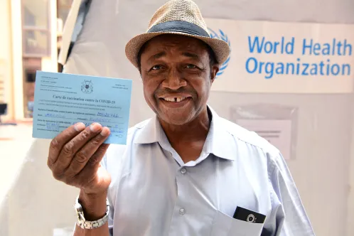 A 63 years old retired UNICEF staff member smiling at the camera holding his vaccination certificate came to get vaccinated at the UN in Ouagadougou, the capital of Burkina Faso.