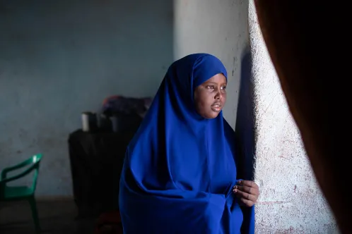 a Somalian girl is looking through the window, 