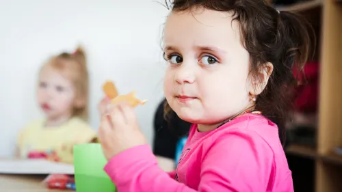 In Michendorf, Germany, young child is eating at her kindergarten. 