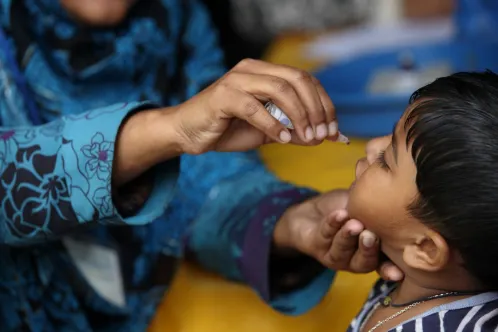 A child receives a polio vaccine dose.