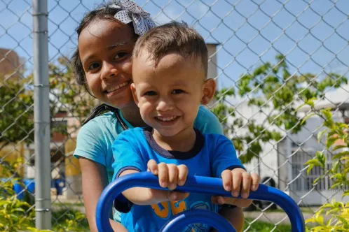 Emily, 9 and Edwin, 3, play outside on world handwashing day in Venezuala.