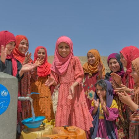 On 14th June 2023, a group of children collect water from a tap, installed with UNICEF support, in Ahu Dara village, Sholgara District in Balkh Province, Afghanistan.