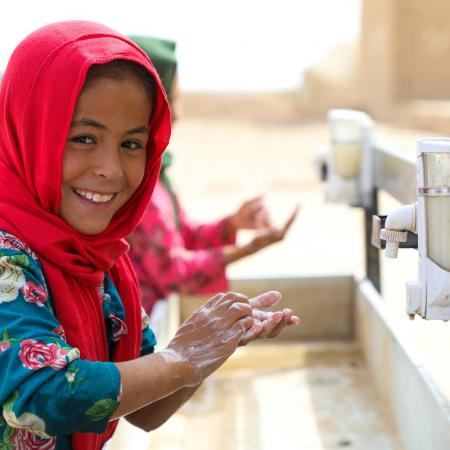 Child washing their hands