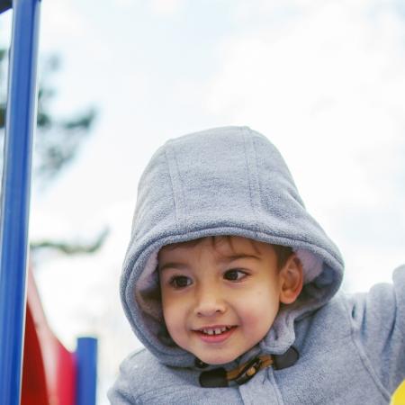 A boy palying at a playground.