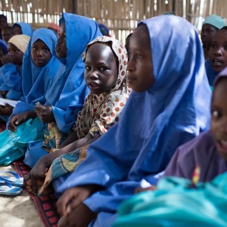 girl sitting in temporary school