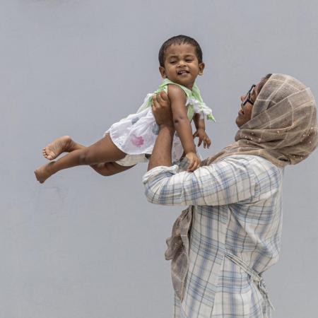 A mother holds her baby in India