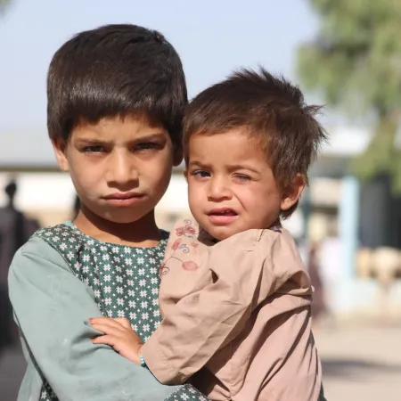 From left: Mohammad Dawood, 5 years old and his brother Sayed Ahmad, 2 years old, have been moved from Maiwand District to Haji IDP camp due to conflict and war. His father owns a shop, and he has five siblings in his family of seven.