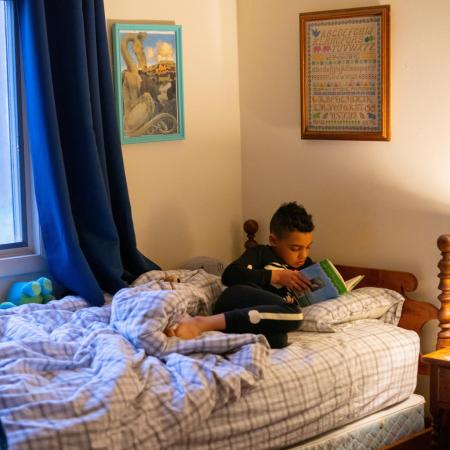 Luka reads in bed before starting his day.