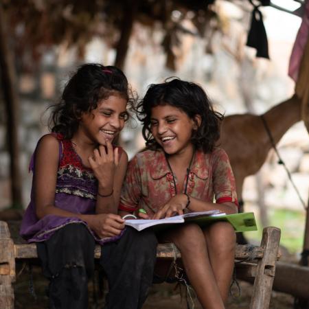 Kanchan (7yrs) and Kashi (7 yr) study at home during the Covid Lockdown . Location : Hindloa Fadia, Limkheda, GujaratLocation : Hindloa Fadia, Limkheda, Gujarat