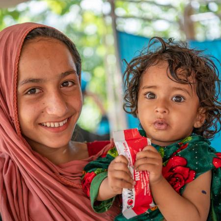 A child named Zarmina receives RUTF at UNICEF-supported mobile health and nutrition in Afghanistan. 