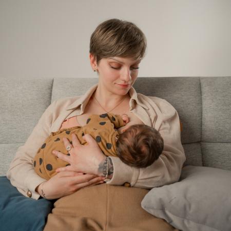 Irina from Moldova is breastfeeding her three-week-old daughter, firmly believing that breastfeeding is the best way to nourish a child during the first months of life.