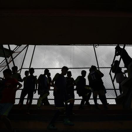 Silhouette of children standing on a balcony 