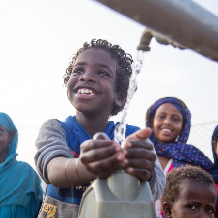 Children collect safe water from a new water station in the village of Gelhanty, Sudan.