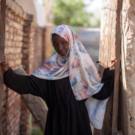 In Sudan, 13-year-old Fiyha smiles at the camera.