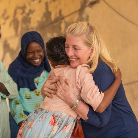 UNICEF Executive Director Catherine Russell hugs 11-year-old Yomna after meeting with her and other adolescent girls displaced by the war, at Abdullah Naj internally displaced people's gathering point in Port Sudan.