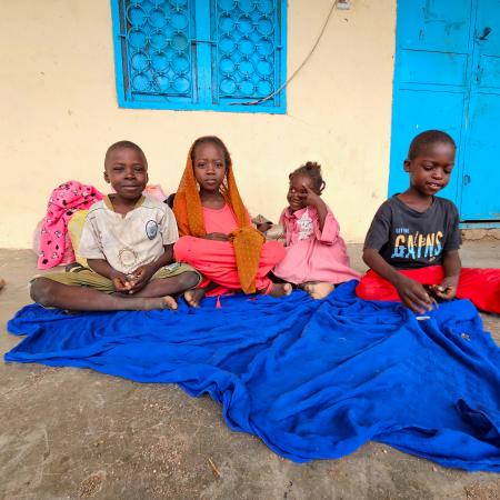 On 1 July 2024, displaced children sit next to their luggage at a school in Gedaref after fleeing Sinja, Sennar state, following the recent clashes.