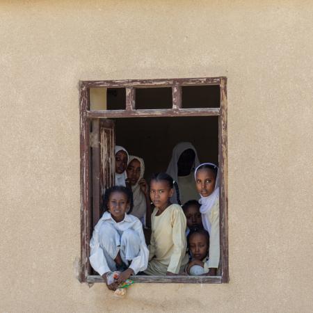 A group of children look out of the window of a school in Port Sudan.