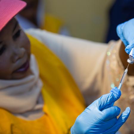 Health worker prepares malaria vaccines in Sudan