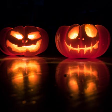 A pair of brightly lit jack o lanterns.